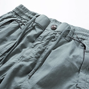 Detail of cargo shorts waist with elastic drawstring and secure zipper pocket design