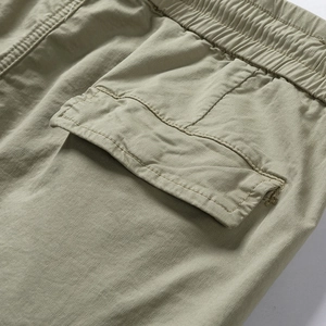 Detailed close-up of tactical cargo shorts with elastic waist and large flap side pocket