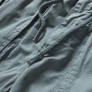 Close-up of cotton cargo shorts featuring durable woven drawstring and reinforced stitching