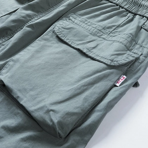 Detail view of cotton cargo shorts with side bellows pocket and elastic drawstring waist