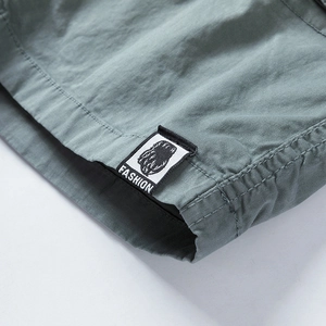 Close-up of the high-quality cotton twill fabric and fashion woven label on cargo shorts