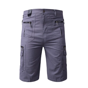 Detail of dark grey-blue men's cargo shorts showing multi-pocket design and zip pockets
