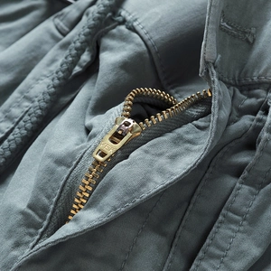 Close-up of metal zipper fly and cotton twill fabric on cargo shorts for men