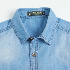 Close-up of light blue cotton denim shirt showing collar details and outdoor label