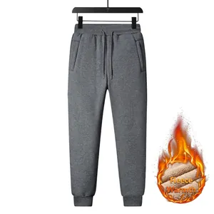Detail of dark grey winter fleece sweatpants with elastic drawstring waist and thermal lining