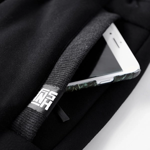 Close-up of winter jogger pocket with ribbed edge and white phone showing depth