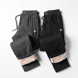 Detail of winter joggers showing thick fleece lining, drawstring waist and zipper pockets