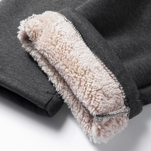 Detailed macro view of dark grey winter pants featuring thick white lamb wool lining