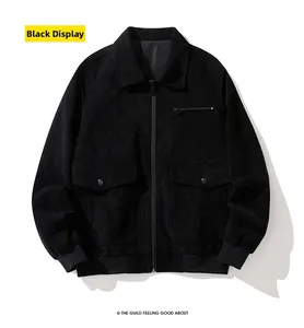Detail of black corduroy jacket showing zipper pockets and ribbed cuffs in workwear style
