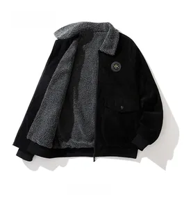 Detail view of men's black corduroy jacket showing grey faux shearling lining and zipper