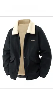 Detail of black corduroy jacket showing beige sherpa lining and snap button closure