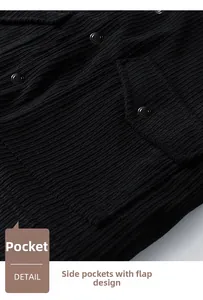 Detailed macro view of corduroy jacket pocket with metallic snap button and flap design