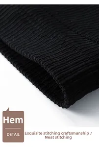Detailed close-up of the ribbed elastic hem on a men's black corduroy winter jacket