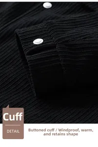 Detail of black corduroy jacket cuff featuring premium silver metal snap button closure