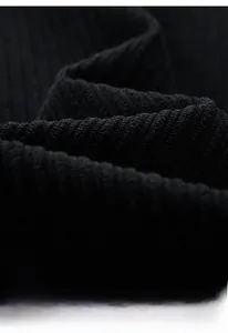 Close-up view of premium black corduroy fabric texture for men's winter jackets