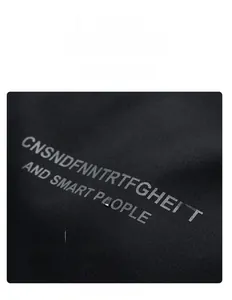 Detail of personalized back print on thick black cotton jacket with letter graphics