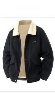 Detail view of black corduroy jacket with white faux lamb wool lining and utility pockets