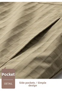 Detail of khaki plaid jacket featuring a precision-stitched side pocket and clean fabric texture