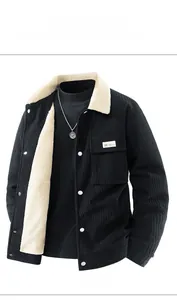Detail view of black corduroy jacket showing white sherpa fleece collar and chest pocket
