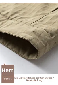 Detailed macro view of the hem showing the subtle checkered texture of the khaki jacket
