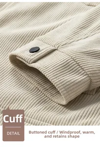 Close-up of beige waffle texture jacket cuff featuring a black button and fine stitching