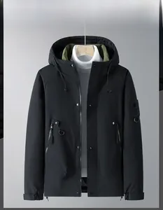 Detail view of winter jacket with windproof matte black fabric and green lining