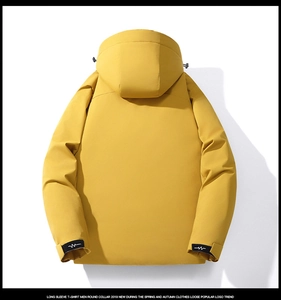 Detail of yellow waterproof winter jacket showing adjustable cuff with wave logo design