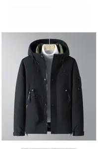 Detail of black hooded winter jacket featuring dual zipper closure and olive green lining