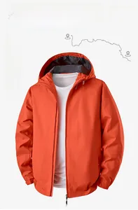 Detail of bright orange hooded outdoor jacket featuring waterproof and windproof fabric