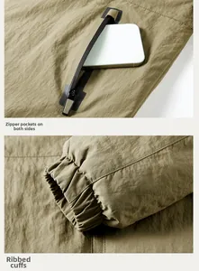 Detailed view of zippered pockets and windproof ribbed cuffs on an outdoor jacket