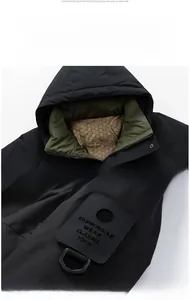 Detail view of winter jacket with green honeycomb lining and branded velcro arm patch