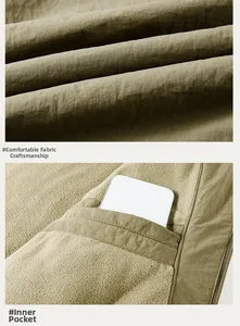 Detail of outdoor jacket showing the durable olive fabric texture and inner fleece pocket