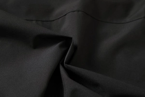 Macro shot of durable black woven polyester fabric texture on winter hooded parka jacket