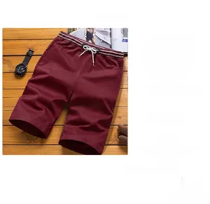 Detail of burgundy casual shorts with elastic drawstring waist on wooden background