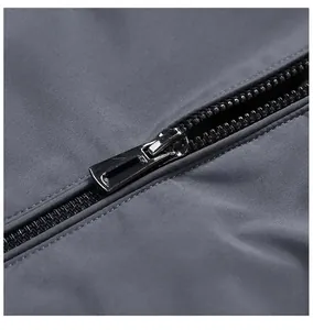 Detail of premium smooth black metal zipper and windproof fabric texture on men's jacket