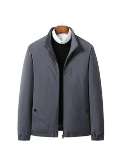 Detail of grey stand-up collar down jacket with metal zipper and snap button pockets