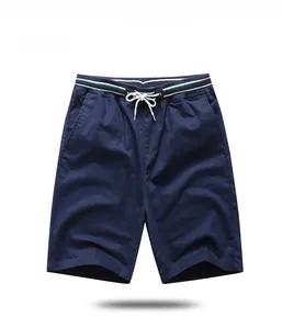 Detail of navy casual shorts with elastic waistband, white drawstring and striped trim