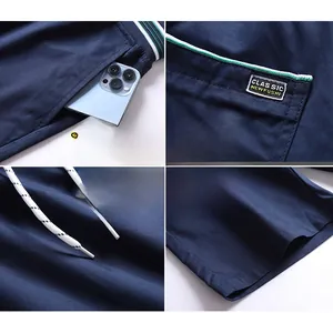 Detail view of men's casual shorts showing side pocket, woven label, and drawstring tie