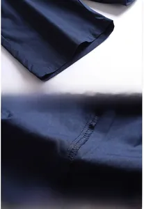 Detailed view of double-stitched hem and reinforced overlock inner seam on navy shorts