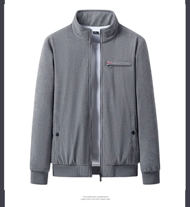 Detail of grey corduroy jacket featuring stand collar and decorative zipper pocket