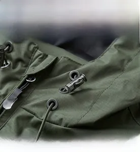 Detail of waterproof green jacket showing adjustable elastic hood drawstring and grid fabric