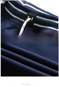 Close-up of men's summer shorts featuring elastic waistband with striped details and drawstring