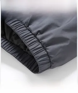 Detailed close-up of the elastic hem on a men's standing collar white duck down jacket
