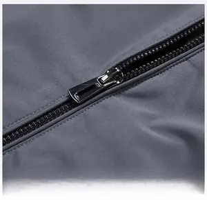 Close-up of a smooth black zipper on a dark grey casual stand collar down jacket