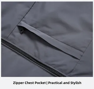 Detail of deep grey men's down jacket showing the zippered chest pocket and premium fabric