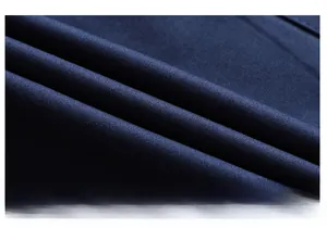 Macro shot of high-quality navy blue twill fabric with soft texture and refined weave