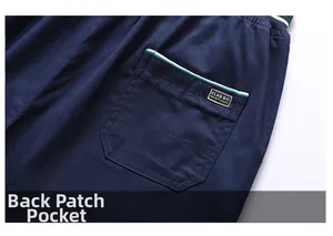 Detail of navy blue casual shorts showing a back patch pocket with woven trim and logo