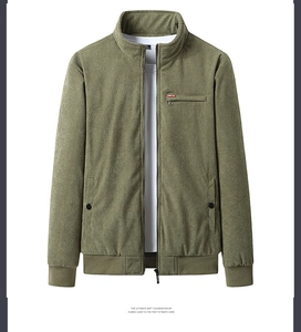 Detailed texture of olive green corduroy fabric on a padded winter jacket for men