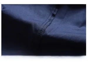 Detailed close-up showing the precise stitching and high-quality seam of navy blue shorts