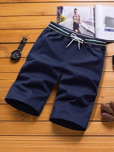 Men's navy casual cotton shorts with striped drawstring waist on wooden background